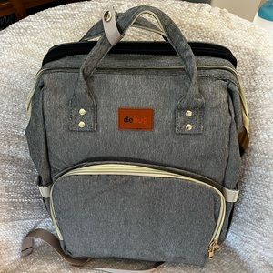Never been used Debug grey diaper bag.  Comes with a portable changing table